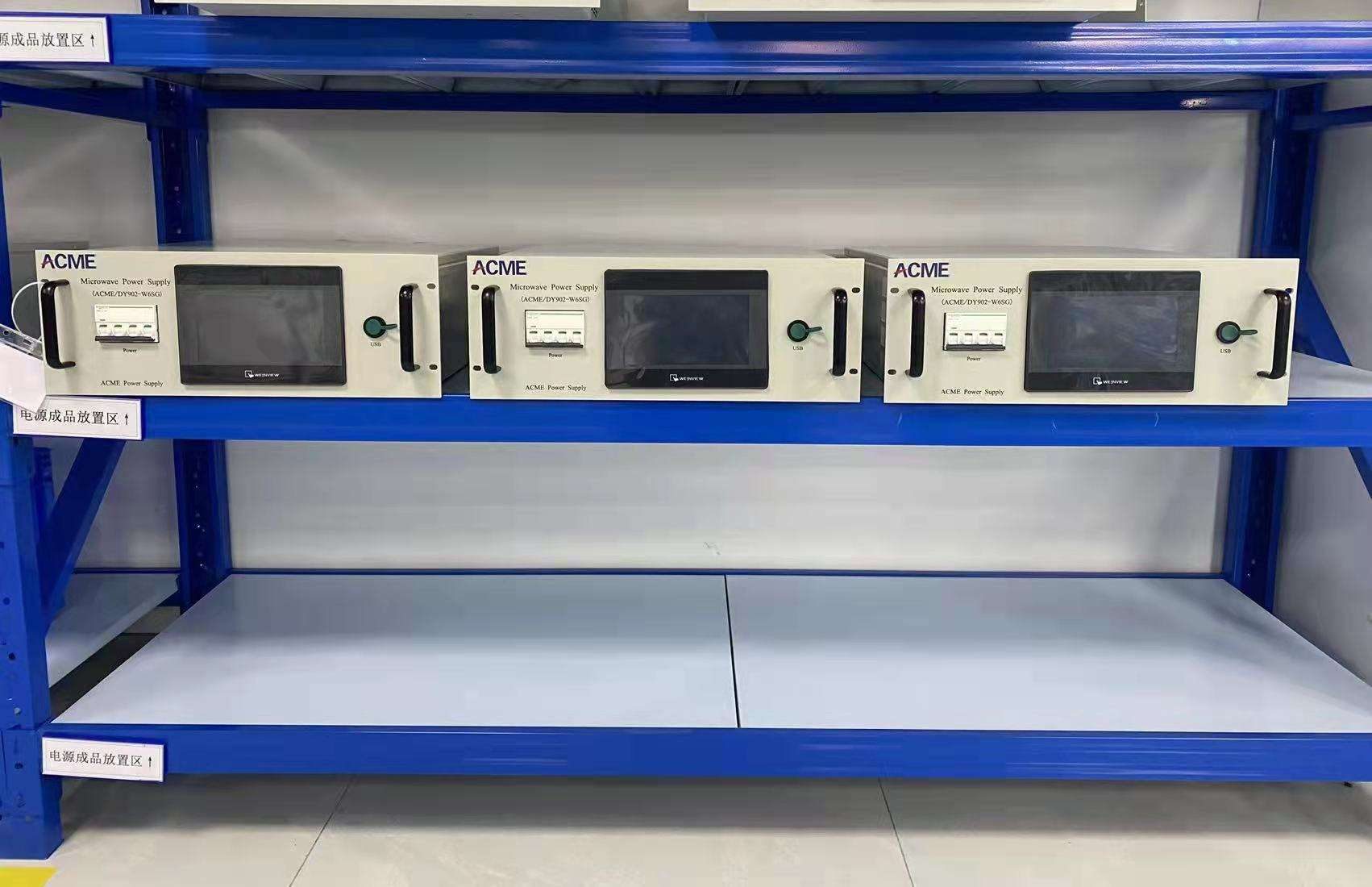 Multiple industrial microwave power supply units arranged on a production rack